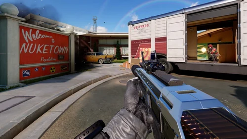 First-person Call of Duty: Mobile gameplay screenshot aiming a rifle at an enemy operator near the Nuketown map's delivery truck
